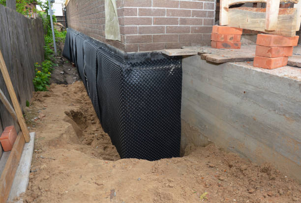 Happy homeowners after waterproofing job in Brick